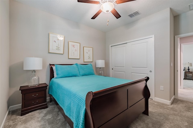 carpeted bedroom with a closet and ceiling fan