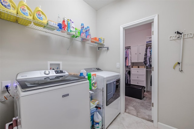 laundry room with washer and clothes dryer and light carpet