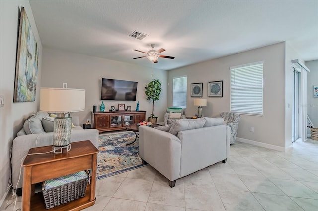 living room featuring ceiling fan and light tile patterned floors