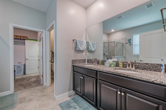 bathroom with a shower with shower door, toilet, and vanity