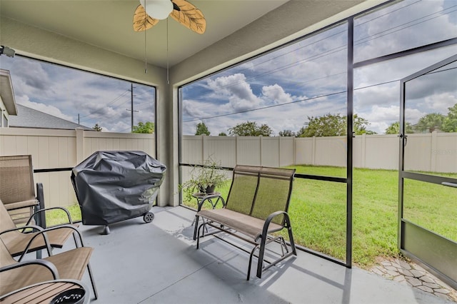 sunroom / solarium featuring a healthy amount of sunlight and ceiling fan