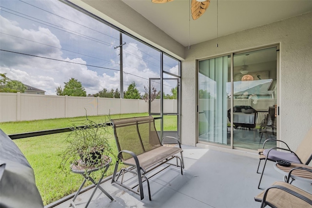 sunroom / solarium featuring ceiling fan