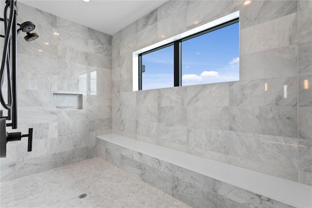 bathroom with a tile shower