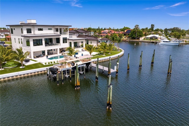 view of dock featuring a patio area, a balcony, and a water view