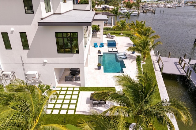 view of pool with an outdoor living space, a water view, and a patio