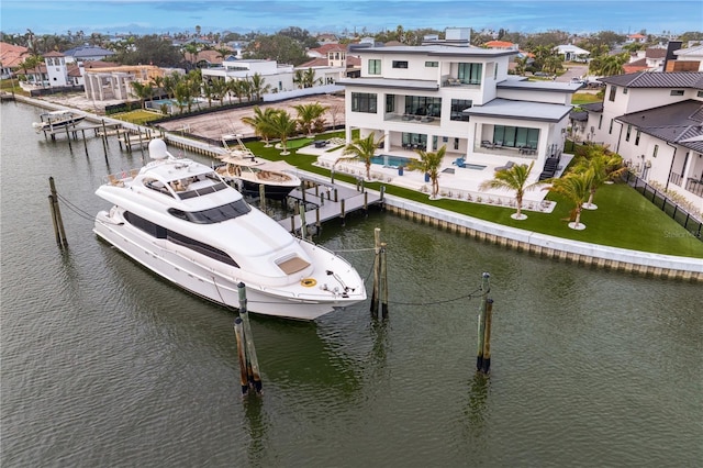 view of dock featuring a yard, a patio area, a balcony, and a water view