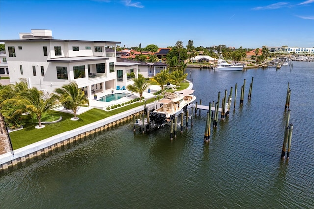 view of dock with a lawn, a water view, and a balcony