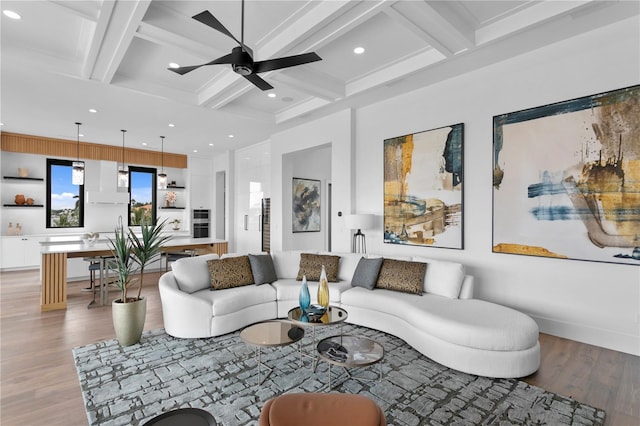 living room with beam ceiling, built in features, light hardwood / wood-style flooring, and coffered ceiling