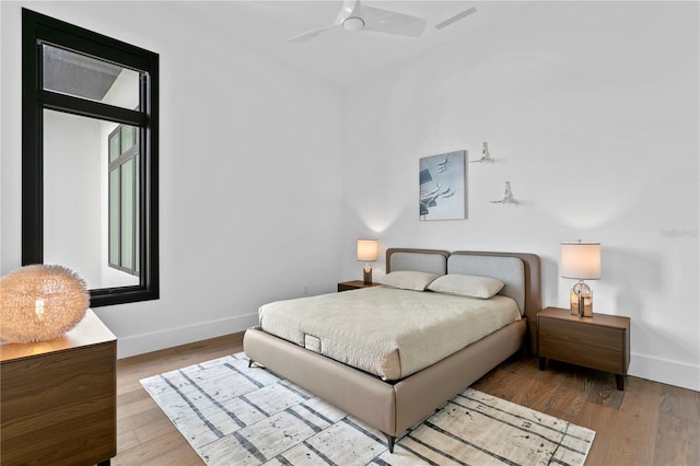 bedroom with ceiling fan and light hardwood / wood-style floors