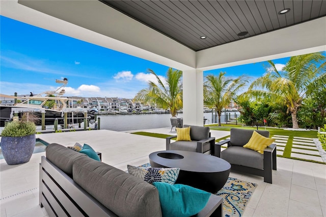 view of patio / terrace featuring outdoor lounge area, a water view, and a dock