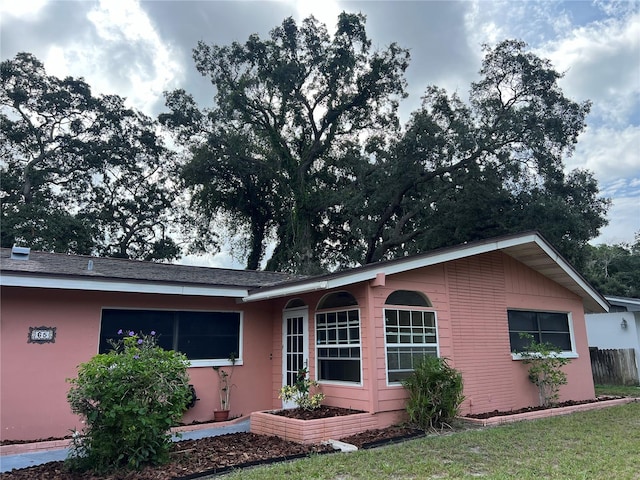 rear view of property featuring a yard