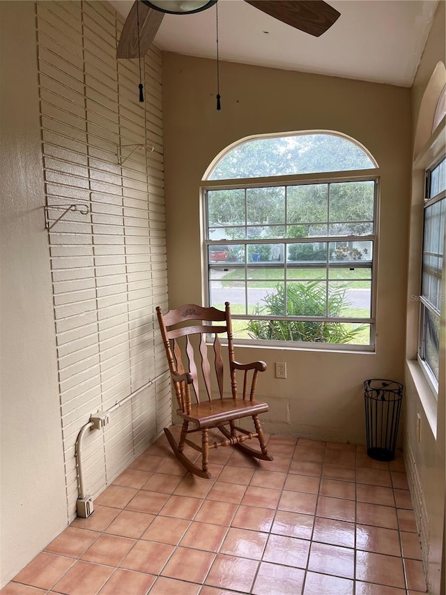 sitting room with ceiling fan and light tile patterned flooring