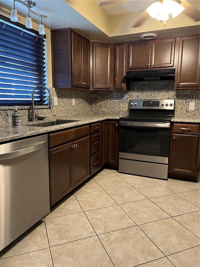 kitchen featuring appliances with stainless steel finishes, dark brown cabinets, sink, and ceiling fan