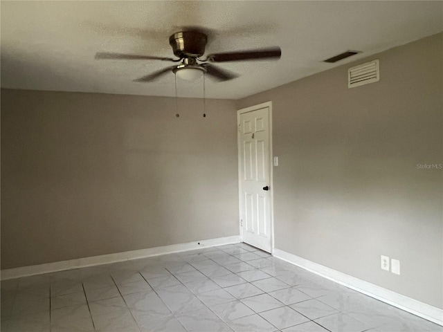 unfurnished room with a textured ceiling and ceiling fan