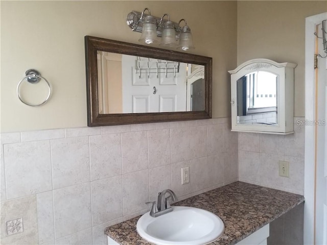 bathroom with tile walls and vanity