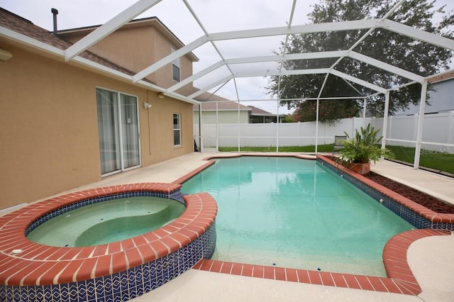 view of swimming pool featuring a lanai, an in ground hot tub, and a patio area