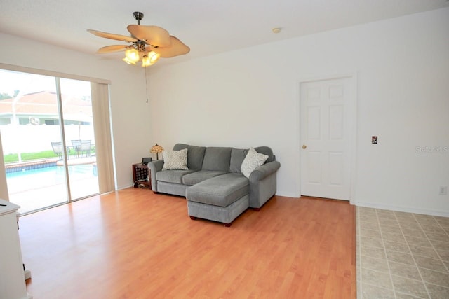 living room featuring ceiling fan and light hardwood / wood-style floors