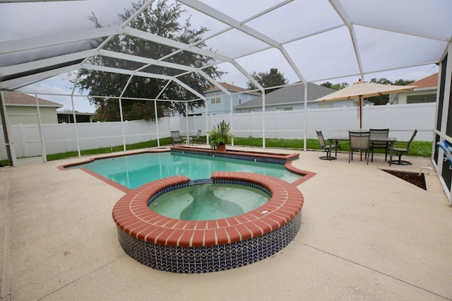 view of swimming pool featuring a lanai, an in ground hot tub, and a patio