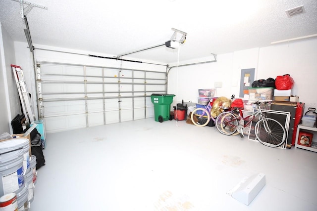 garage featuring a garage door opener and electric panel