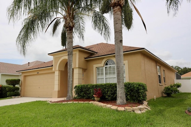 mediterranean / spanish house with a front lawn and a garage