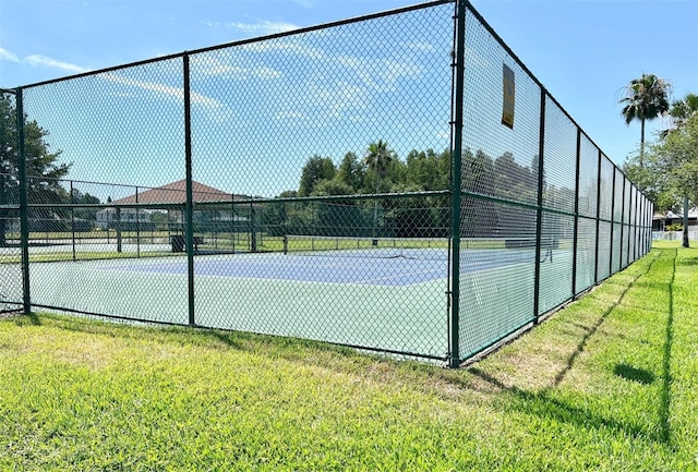 view of sport court featuring a lawn