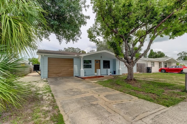 ranch-style house with a garage, a front yard, and central AC unit