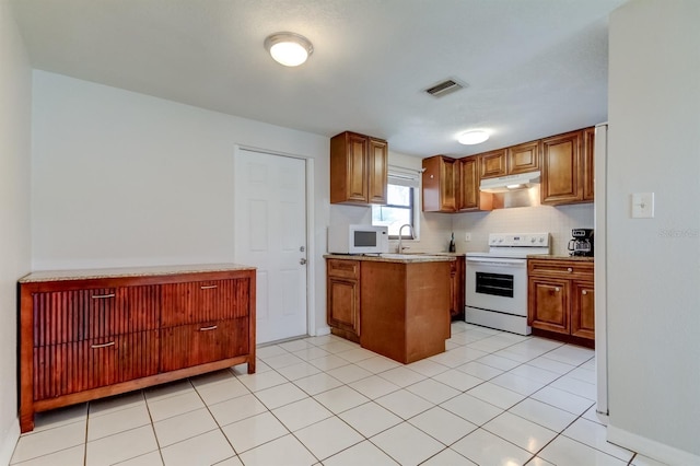 kitchen with light tile patterned floors, range with electric cooktop, sink, and decorative backsplash