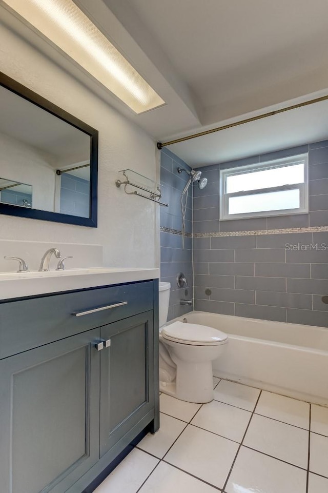 full bathroom featuring vanity, toilet, and tiled shower / bath combo