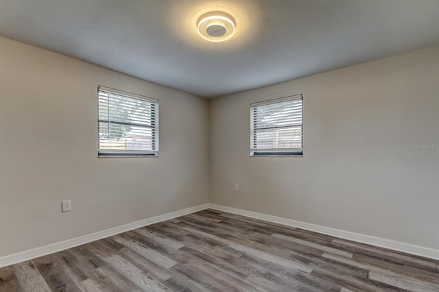 spare room with hardwood / wood-style floors and a healthy amount of sunlight