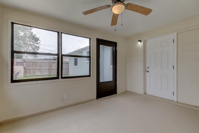 unfurnished bedroom with ceiling fan and multiple windows