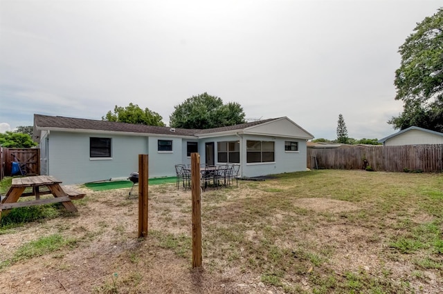 rear view of property with a yard