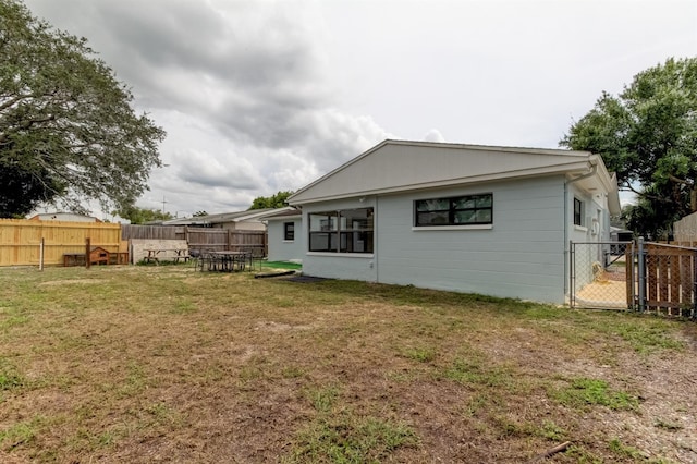 back of property featuring a yard