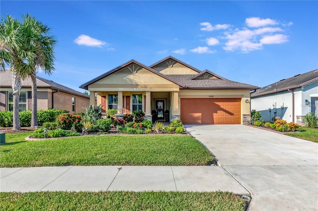 craftsman inspired home with a garage and a front lawn