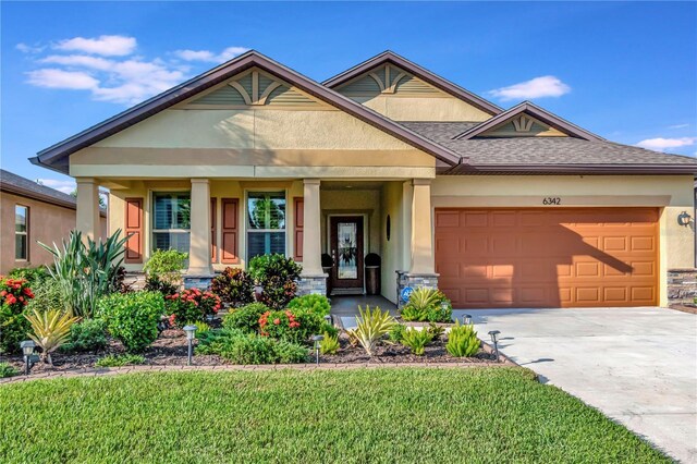 craftsman-style home featuring a garage and a front lawn