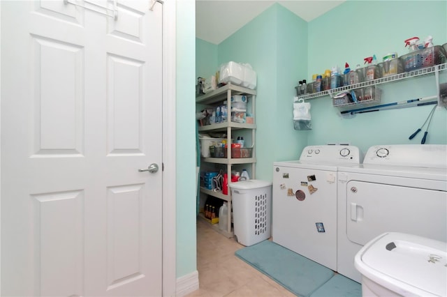 interior space with washing machine and clothes dryer and light tile patterned floors