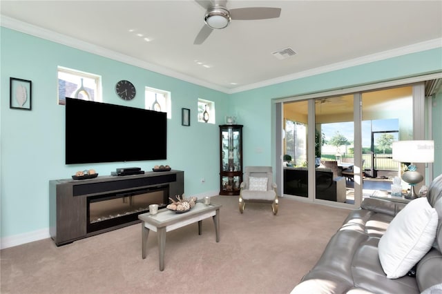 living room featuring ceiling fan, light colored carpet, and crown molding