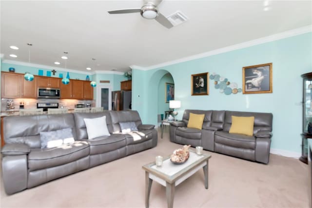 carpeted living room with ceiling fan and crown molding