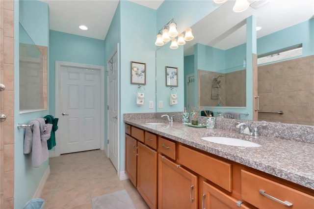 bathroom with ceiling fan, vanity, and tiled shower