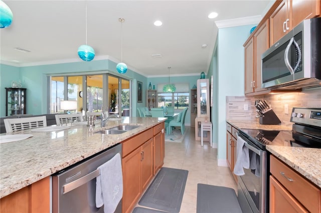 kitchen featuring appliances with stainless steel finishes, tasteful backsplash, decorative light fixtures, ornamental molding, and sink