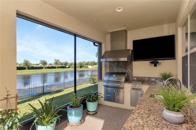 interior space featuring wall chimney exhaust hood, a fireplace, and tasteful backsplash