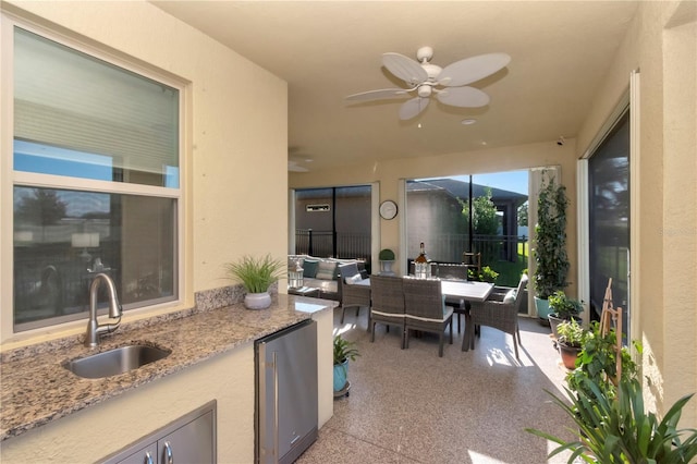 view of patio / terrace with ceiling fan and sink