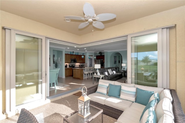 living room with light hardwood / wood-style flooring and ceiling fan