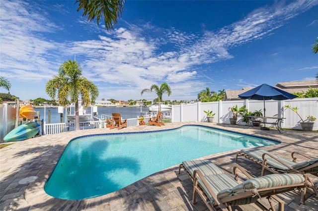 view of swimming pool with a water view and a patio