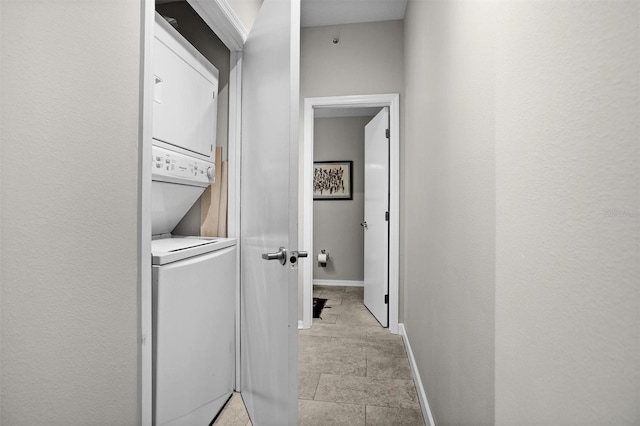 laundry room with stacked washer / dryer