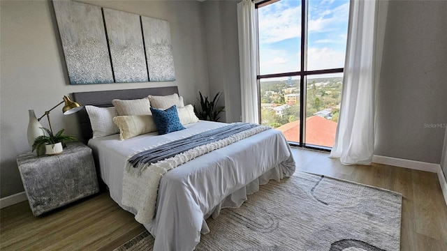 bedroom with hardwood / wood-style flooring and access to outside