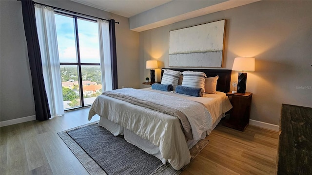 bedroom featuring access to outside and light hardwood / wood-style floors