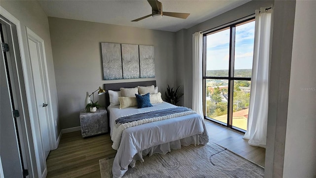 bedroom with dark hardwood / wood-style flooring, access to outside, and ceiling fan