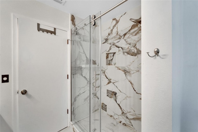 bathroom featuring a shower with shower door