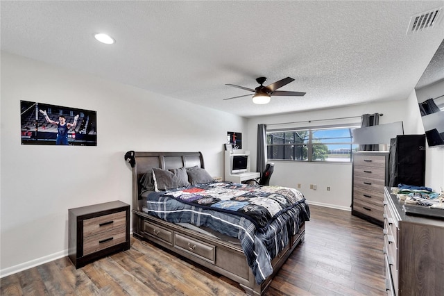 bedroom featuring a textured ceiling, dark hardwood / wood-style flooring, and ceiling fan