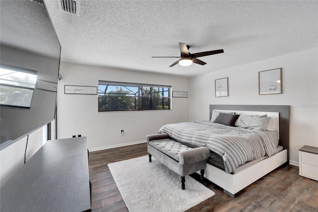 bedroom featuring a textured ceiling, dark hardwood / wood-style flooring, and ceiling fan